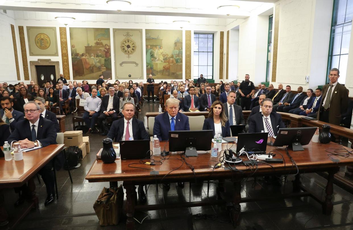 Former President Donald Trump (C) sits with his attorneys Christopher Kise (2-L) and Alina Habba (2-R) as he attends the first day of his civil fraud trial in New York on 2 October 2023 (EPA)