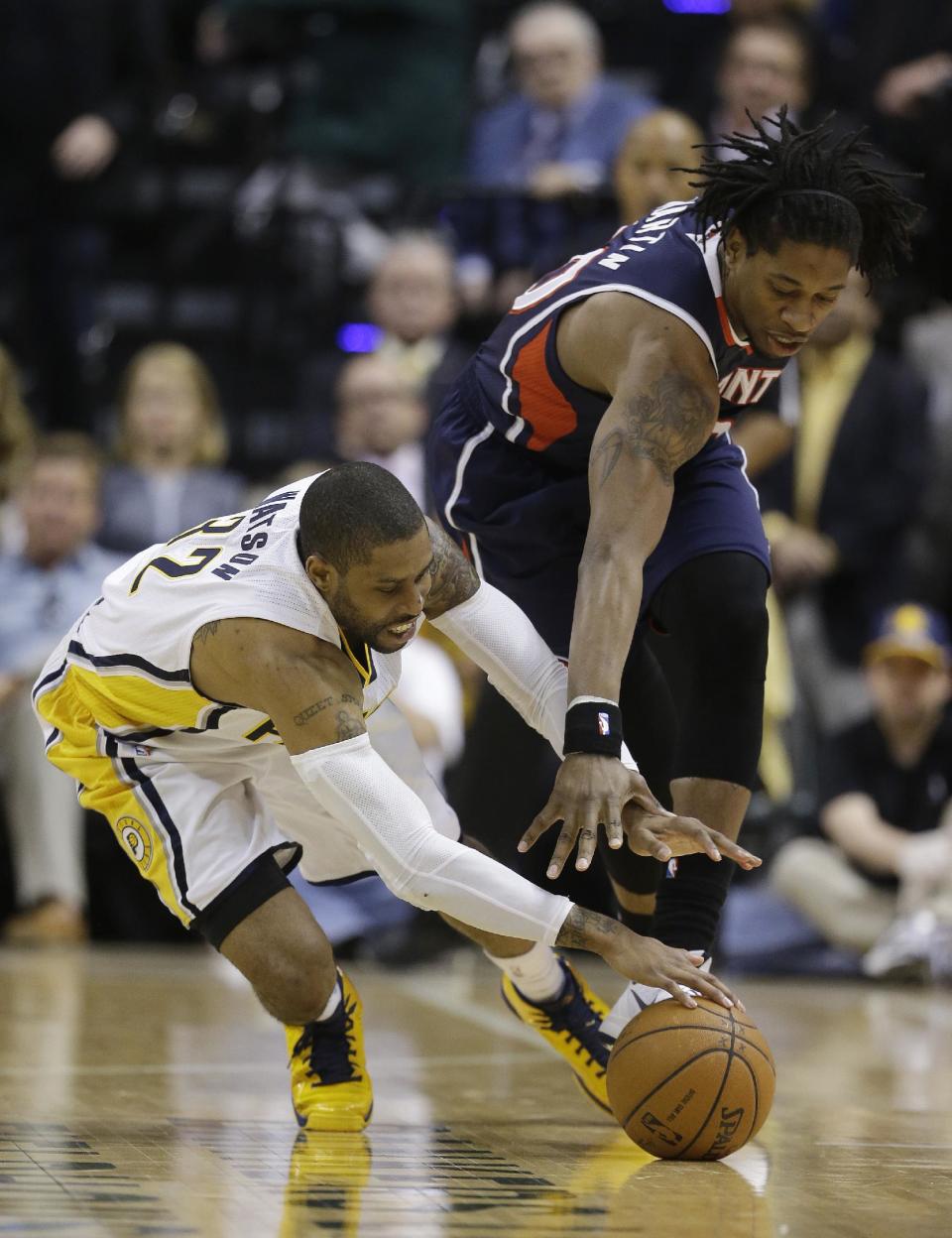 Indiana Pacers' C.J. Watson (32) and Atlanta Hawks' Cartier Martin (20) dive for a loose ball during the second half in Game 2 of an opening-round NBA basketball playoff series Tuesday, April 22, 2014, in Indianapolis. Indiana defeated Atlanta 101-85. (AP Photo/Darron Cummings)