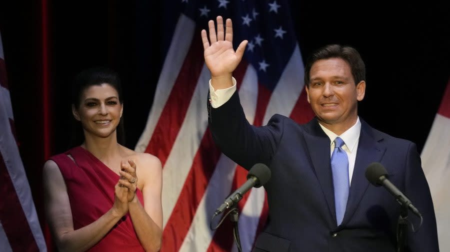 Florida Republican Gov. Ron DeSantis waves as his wife, Casey, applauds after a televised debate against Charlie Crist on Oct. 24, 2022, in Fort Pierce, Fla. (AP Photo/Rebecca Blackwell)