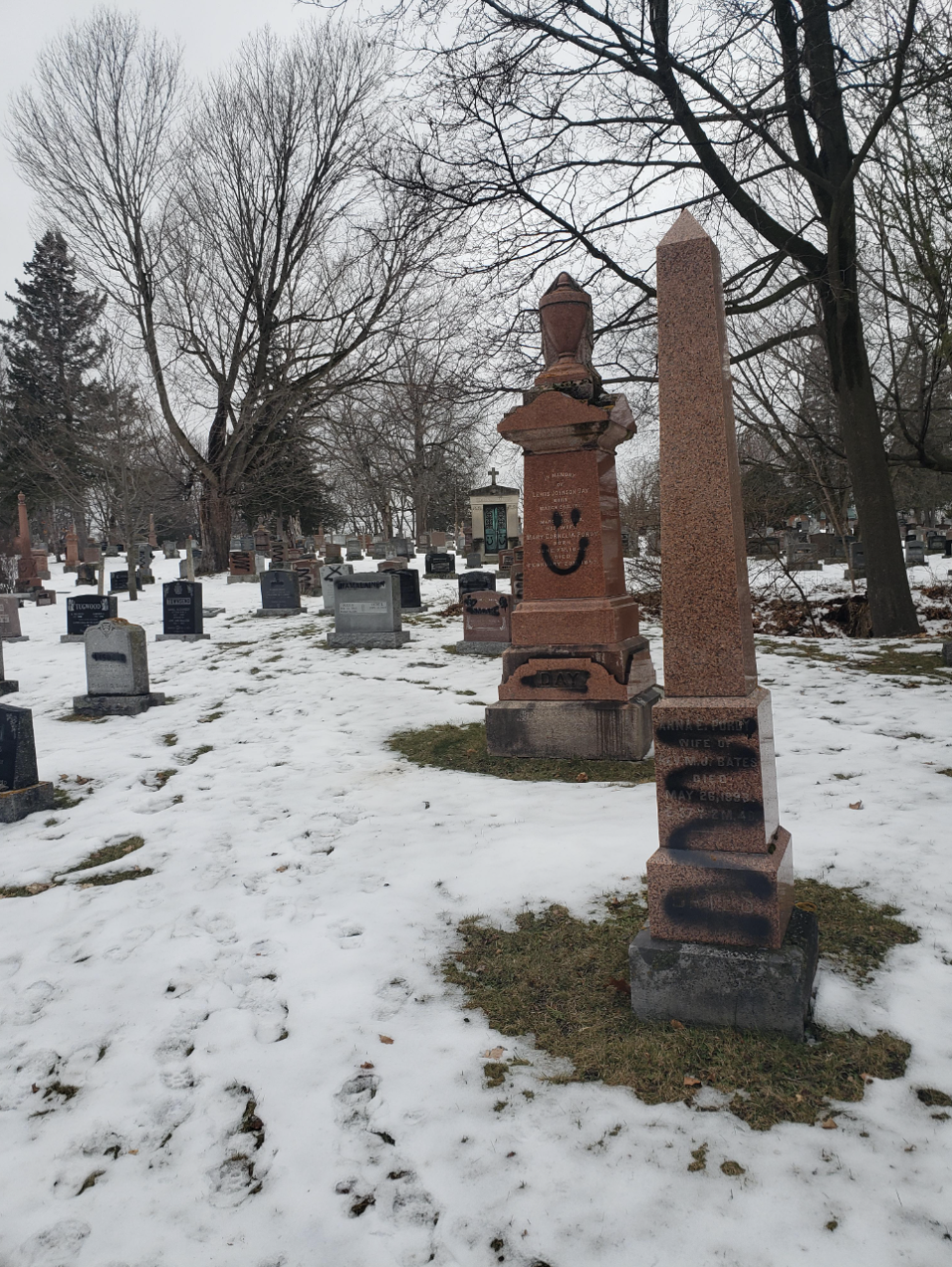 Gravestones with spray paint on them