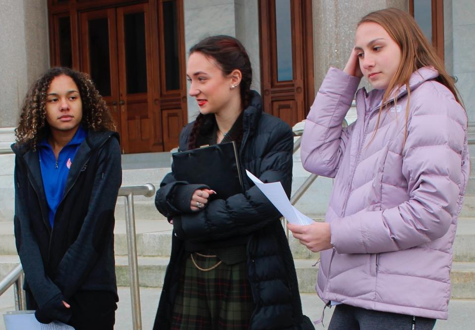 Alanna Smith, left, Selina Soule, center and and Chelsea Mitchell speak at a Feb. 12 news conference addressing their lawsuit. (AP Photo/Pat Eaton-Robb)