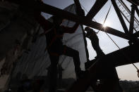 Workers climb on a metal frame beside the damaged cupola, in the early stages of reconstruction work at Nuestra Senora de Los Angeles, or Our Lady of Angels church, three years after an earthquake collapsed nearly half of its 18th-century dome in Mexico City, Wednesday, Sept. 23, 2020. About half of the 2,340 colonial-era buildings and churches damaged in the 2017 Mexico quake still need to be repaired, restored or partially rebuilt. (AP Photo/Rebecca Blackwell)