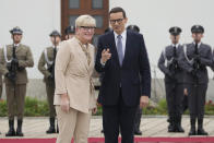 Lithuanian Prime Minister Ingrida Simonyte, left, being greeted by Poland's Prime Minister Mateusz Morawiecki on a visit for talks that include the region's security in the face of migrant pressure on the two countries' borders with Belarus, in Warsaw, Poland, on Friday, Sept. 17, 2021. (AP Photo/Czarek Sokolowski)