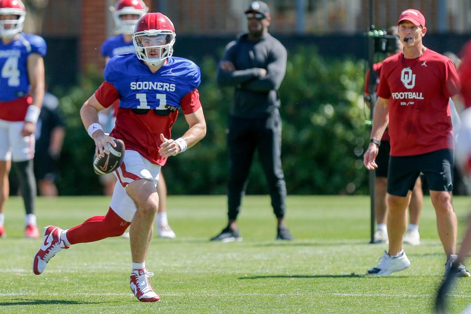 Jackson Arnold (11) scrambles during an Oklahoma football practice in Norman, Okla., on Friday, April 12, 2024.