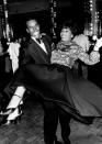 <p>Shirley Bassey gets a lift from Sterling St. Jacques on the dance floor of Studio 54. The actor and singer were dressed in black tie for the evening, which wasn't typical attire for the New York nightclub. </p>