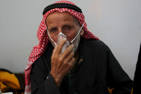 FILE PHOTO: A man breathes through an oxygen mask after what activists said was a chlorine gas attack on Kansafra village at Idlib countryside, Syria May 7, 2015. REUTERS/Abed Kontar/File Photo