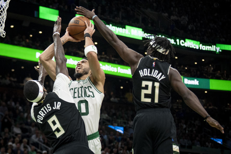 BOSTON, MASSACHUSETTS - MAY 11: Jayson Tatum #0 of the Boston Celtics goes to the basket against Bobby Portis #9 of the Milwaukee Bucks and Jrue Holiday #21 of the Milwaukee Bucks during the first half of Game Five of the Eastern Conference Semifinals at TD Garden on May 11, 2022 in Boston, Massachusetts.  NOTE TO USER: User expressly acknowledges and agrees that, by downloading and or using this photograph, User is consenting to the terms and conditions of the Getty Images License Agreement.  (Photo by Maddie Malhotra/Getty Images)