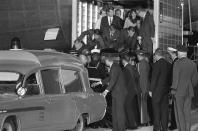 The casket containing the body of slain President John F. Kennedy is moved to a Navy ambulance from the Presidential plane which arrived from Dallas, Texas, where Kennedy was assassinated, to Andrews Air Force Base, Md. on Nov. 22, 1963. First Lady Jacqueline Kennedy is behind on the elevator. Attorney General Robert Kennedy, his brother, is beside her. Lawrence O’Brien of the White House staff is at the right. Secret Service men are directly behind the casket. (Photo: AP)