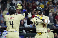 Arizona Diamondbacks' Lourdes Gurriel Jr. (12) celebrates his two-run home run against the Chicago Cubs with Diamondbacks' Ketel Marte (4) during the third inning of a baseball game Tuesday, April 16, 2024, in Phoenix. (AP Photo/Ross D. Franklin)