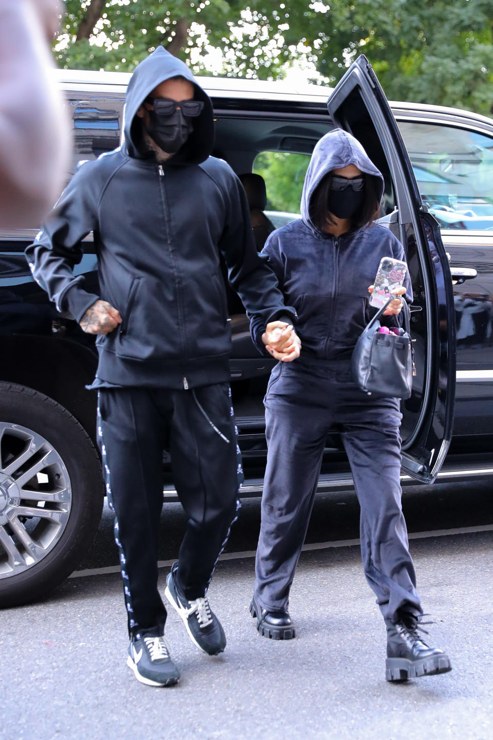 Kourtney Kardashian Goes Undercover in Black Sweatsuit and Lug-Sole Boots  in NYC