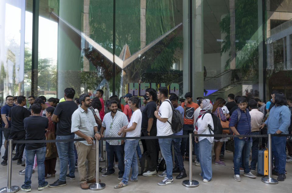 Dozens of people lined up outside for the grand opening Apple Inc. first flagship store in Mumbai, India, Tuesday, April 18, 2023. Apple Inc. is set to open its first flagship store in India in a much-anticipated launch Tuesday that highlights the company's growing aspirations to expand in the country it also hopes to turn into a potential manufacturing hub. (AP Photo/Rafiq Maqbool)