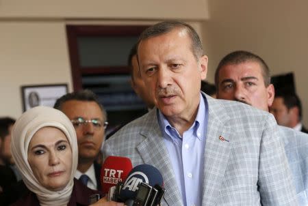 Prime Minister and presidential candidate Tayyip Erdogan talks with media during presidential elections in Istanbul August 10, 2014. REUTERS/Murad Sezer
