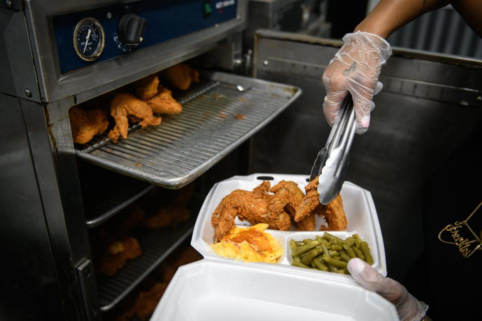 Tyshia Smith puts an order together for a customer at Barbara Ann's Southern Fried Chicken restaurant at 3740 S. Main St., Hope Mills.