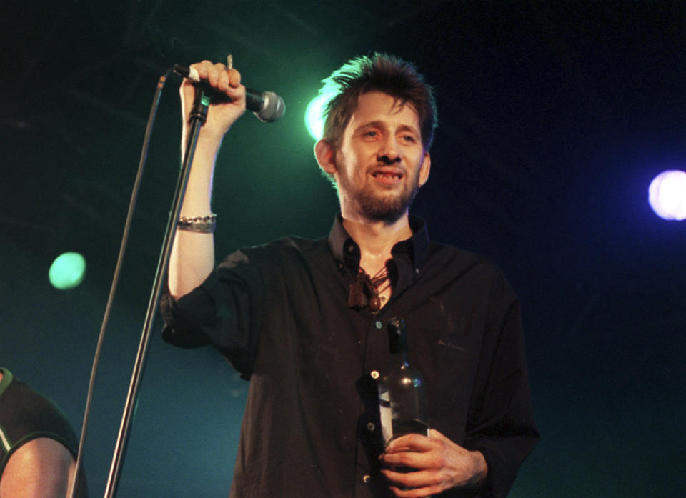 FILE - Former Pogues member Shane MacGowan performs on stage with his group The Popes, at the 10th annual Fleadh, in Finsbury Park, north London, July 10, 1999. Macgowan, the singer-songwriter and frontman of The Pogues, best known for their ballad “Fairytale of New York,” has died. He was 65. His family said in a statement that "it is with the deepest sorrow and heaviest of hearts that we announce the passing of our most beautiful, darling and dearly beloved Shane Macgowan.” The singer died peacefully early Thursday, Nov. 30, 2023 with his family by his side, the statement added. (Michael Walter/PA via AP, File)