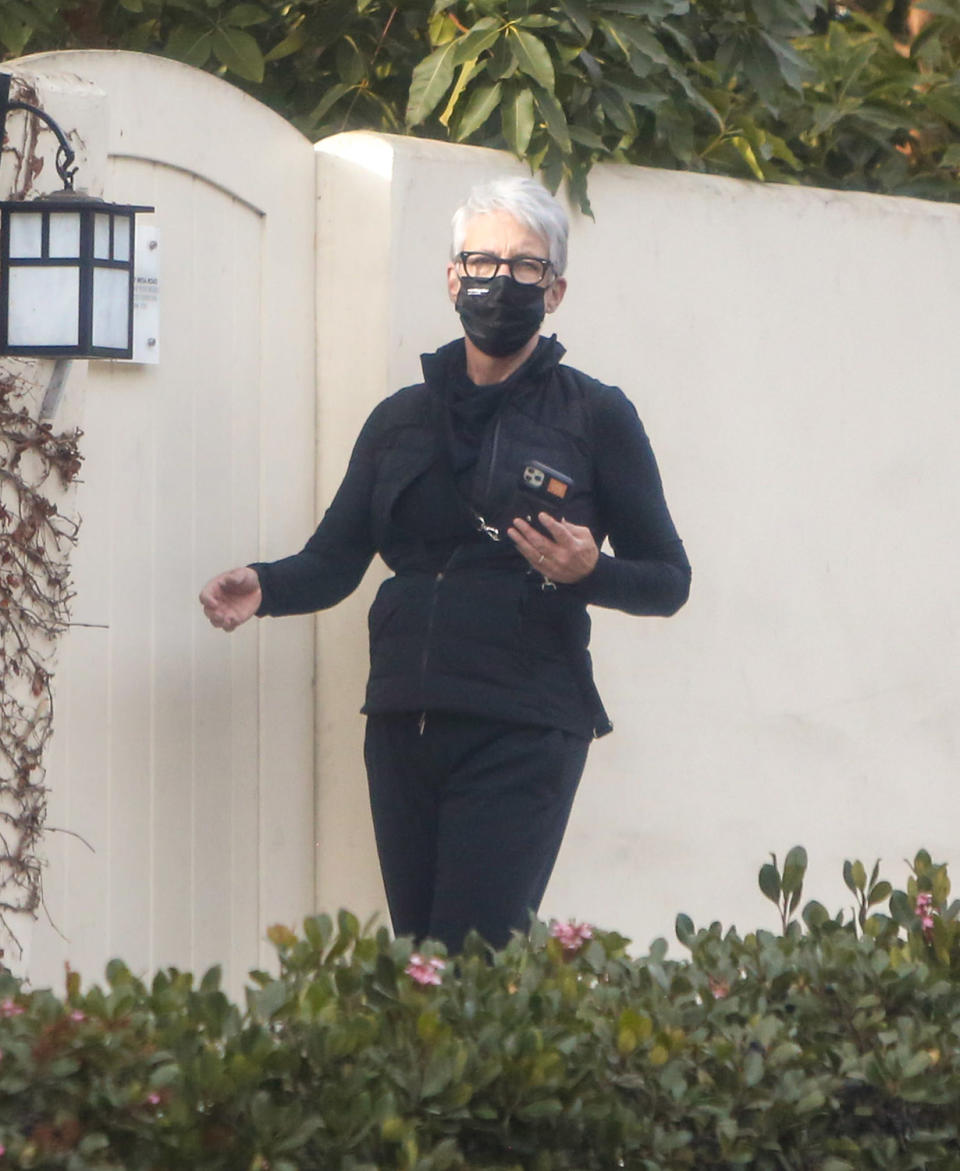 <p>Jamie Lee Curtis masks up for a solo stroll on Wednesday around her neighborhood in L.A. </p>