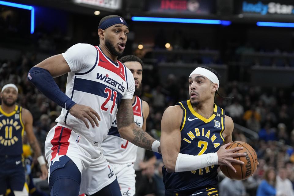 Indiana Pacers' Andrew Nembhard (2) goes to the basket against Washington Wizards' Daniel Gafford (21) during the first half of an NBA basketball game Wednesday, Jan. 10, 2024, in Indianapolis. (AP Photo/Darron Cummings)