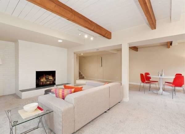 Basement with exposed wood beam and shiplap ceiling