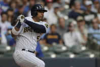 Milwaukee Brewers' Eduardo Escobar watches his two-RBI single during the second inning of a baseball game against the New York Mets, Sunday, Sept. 26, 2021, in Milwaukee. (AP Photo/Aaron Gash)