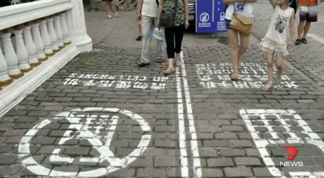 China, Thailand, Belgium and the US have installed designated walkways for people who want to walk and text. Photo: 7 News