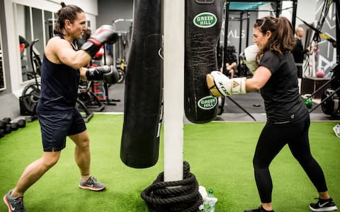 Scarlett Yianni, 32, and her boyfriend Jack Johnstone, 33, from east London do boxing classes together at their gym. - Credit:  John Nguyen/JNVisuals