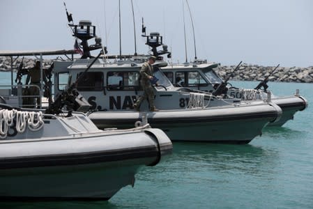 Members of the U.S. Navy Fifth Fleet prepare to escort journalists to the Japanese-owned Kokuka Courageous tanker at a U.S. NAVCENT facility near the port of Fujairah