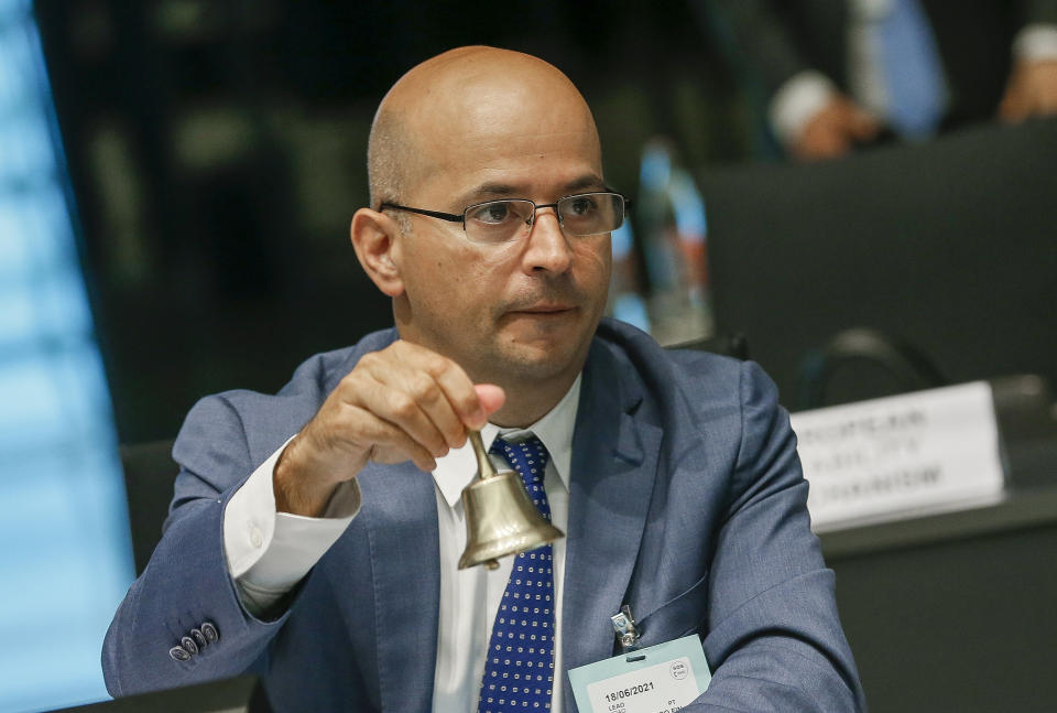 FILE - Portuguese Finance Minister Joao Leao rings a bell to signal the start of the Ecofin meeting at the European Council building in Luxembourg on June 18, 2021. Finance ministers from the 19 countries that share the euro currency may decide Thursday, June 16, 2022 on a successor to Germany’s Klaus Regling as managing director of the European Stability Mechanism. In the running are two former finance ministers, Pierre Gramegna of Luxembourg and Joao Leao of Portugal, plus a senior European Commission official from Italy, Marco Buti. (Julien Warnand/ Pool Photo via AP, File)