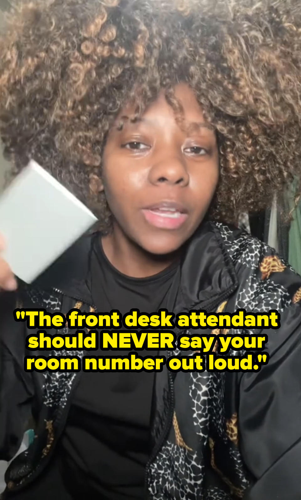 Patrice continues talking in the video with the text: "The front desk attendant should never say your room number out loud"