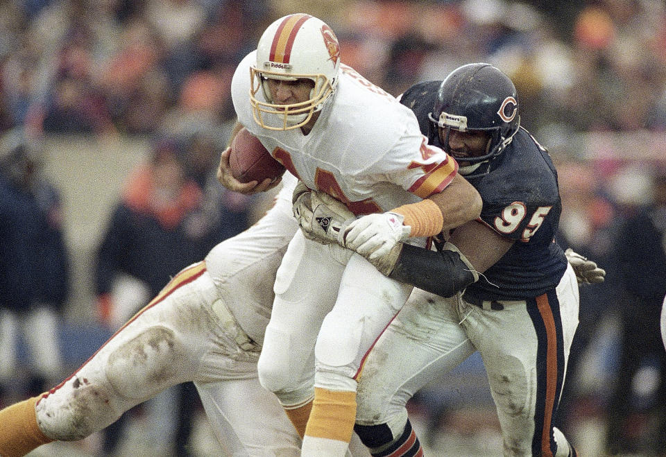 FILE - In this Nov. 6, 1988, file photo, Chicago Bears defensive end Richard Dent (95) sacks Tampa Bay Buccaneers quarterback Vinny Testaverde in the fourth quarter of an NFL football game in Chicago. A U.S. appeals court has revived a lawsuit against the NFL by former players, including Dent, who claim the league illegally plied them with powerful prescription painkillers to keep them on the field. (AP Photo/John Swart, File)