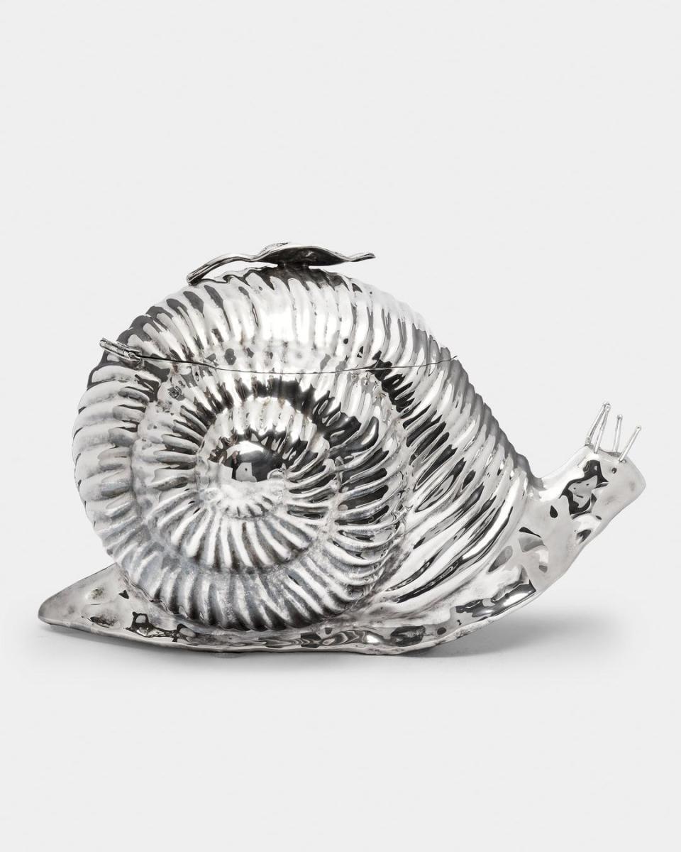 a silver bowl with a drawing of a bird on it