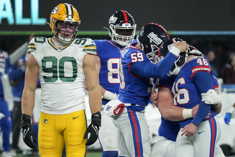 New York Giants long snapper Casey Kreiter (59) congratulates place kicker Randy Bullock (46) after Bullock kicked a game-winning field goal with one second remaining in the fourth quarter of an NFL football game against the Green Bay Packers, Monday, Dec. 11, 2023, in East Rutherford, N.J. (AP Photo/Seth Wenig)