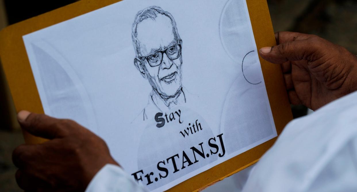 A priest holds a placard with the image of Jesuit priest Father Stan Swamy during a protest in Jharkhand in October 2020. Photo: Noah Seelam/AFP via Getty Images