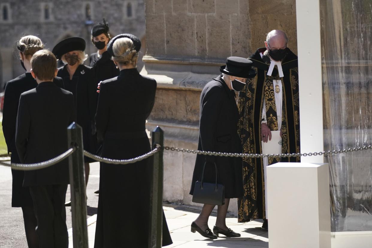 Queen Elizabeth II is greeted by the Right Reverend David Conner, Dean of Windsor, as she arrives at St George's Chapel for Britain Prince Philip's funeral at Windsor Castle, Windsor, England, Saturday April 17, 2021.