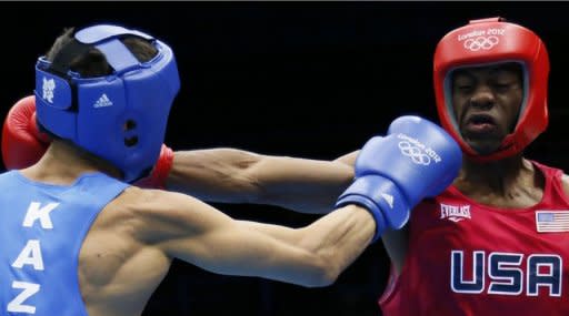 Jamel Herring (R) of the USA exchanges blows with Daniyar Yeleussinov (L) of Kazakhstan during their first round Light-Welterwight (64kg) boxing match of the London 2012 Olympics at the ExCel Arena in London. Yeleussinov was awarded a 19-9 points victory. A