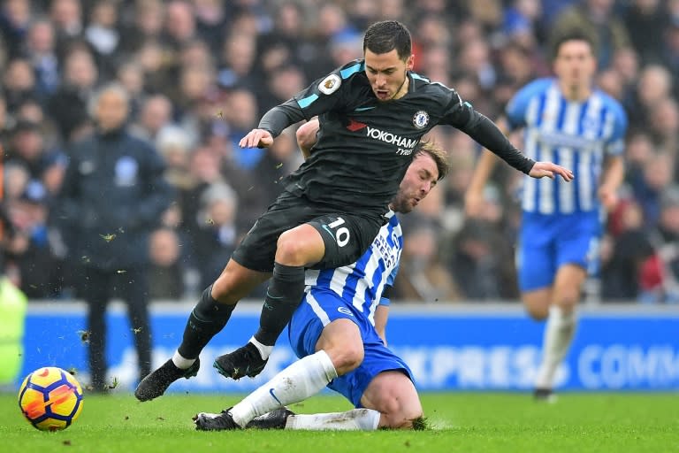 Chelsea midfielder Eden Hazard (left) rides a tackle by Brighton's Dale Stephens during their English Premier League match in Brighton on January 20, 2018