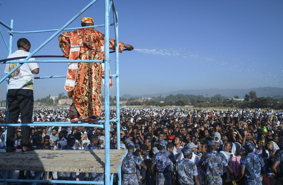 Christians from the Ethiopian Orthodox church receive a spray of holy water as they celebrate the annual festival of Timkat, or Epiphany, marking the baptism of Jesus Christ in the River Jordan, in the capital Addis Ababa, Ethiopia Monday, Jan. 20, 2020. During Timkat celebrations elsewhere in the country, in the city of Gondar, at least three people are dead after a wooden stand erected for the event collapsed on Monday, according to a hospital source. (AP Photo)