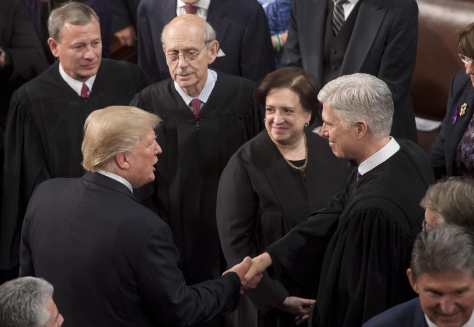 President Trump shakes hands with Supreme Court Justice Neil Gorsuch as Justices John Roberts, Stephen Breyer, and Elena Kagan look on, following Trump’s State of the Union address Jan. 30, 2018. (Photo: Saul Loeb/AFP/Getty Images)