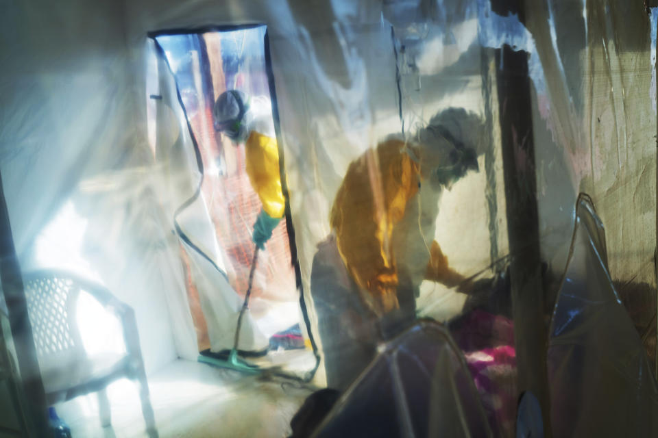 FILE - In this Saturday, July 13, 2019 file photo, health workers wearing protective suits tend to an Ebola victim kept in an isolation tent in Beni, Congo. The World Health Organization on Thursday, June 25, 2020, has declared an end to the second deadliest Ebola outbreak in history, in Eastern Congo that killed 2,280 people over nearly two years. (AP Photo/Jerome Delay, File)