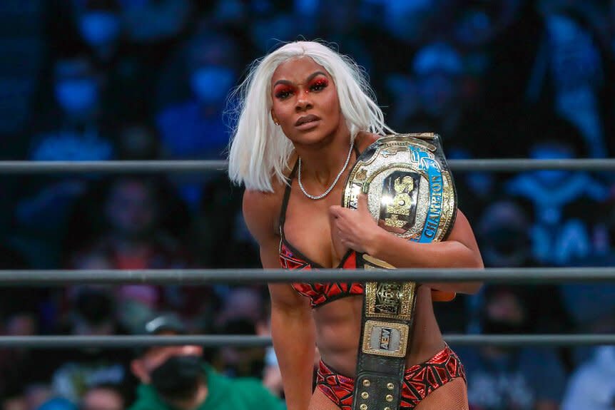 Jade Cargill holds her on her shoulder while standing in the ring