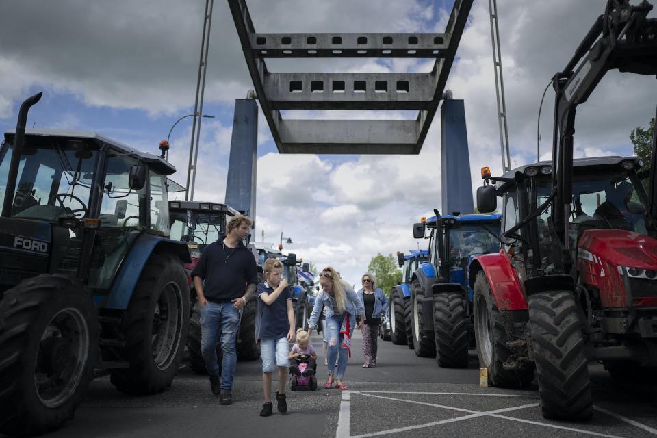 Dutch farmers, angry at government plans to slash emissions, blockade a draw bridge at a lock in the Princess Margriet canal in Gaarkeuken, northern Netherlands, on July 4, 2022. (AP Photo/Peter Dejong)