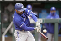 Toronto Blue Jays' Randal Grichuk breaks his bat as he hits for a single during the first inning against the Kansas City Royals in the first baseball game of a doubleheader, Saturday, April 17, 2021, in Kansas City, Mo. (AP Photo/Charlie Riedel)