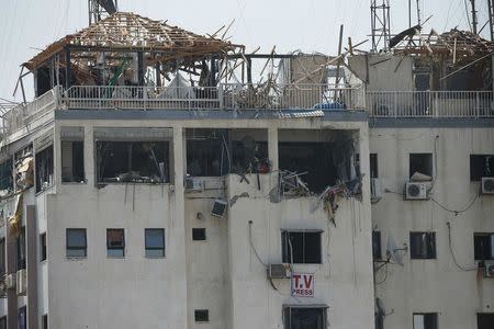 Damage is seen at Hamas' Al-Aqsa TV office in a building that houses other media offices, which witnesses said was hit in an Israeli air strike, in Gaza City July 29, 2014. REUTERS/Suhaib Salem