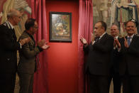 From second left, German Foreign Minister Heiko Mass, Italian Culture Minister Alberto Bonisoli, Uffizi Gallery director Eike Schmidt and Italian Foreign Minister Enzo Moavero Milanesi attend the unveiling of the "Vase of Flowers" painting by Jan van Huysum, at the Pitti Palace, part of the Uffizi Galleries, in Florence, Italy, Friday, July 19, 2019. Germany returned the Dutch still-life after it was stolen by Nazi troops during WWII. (AP Photo/Gregorio Borgia)