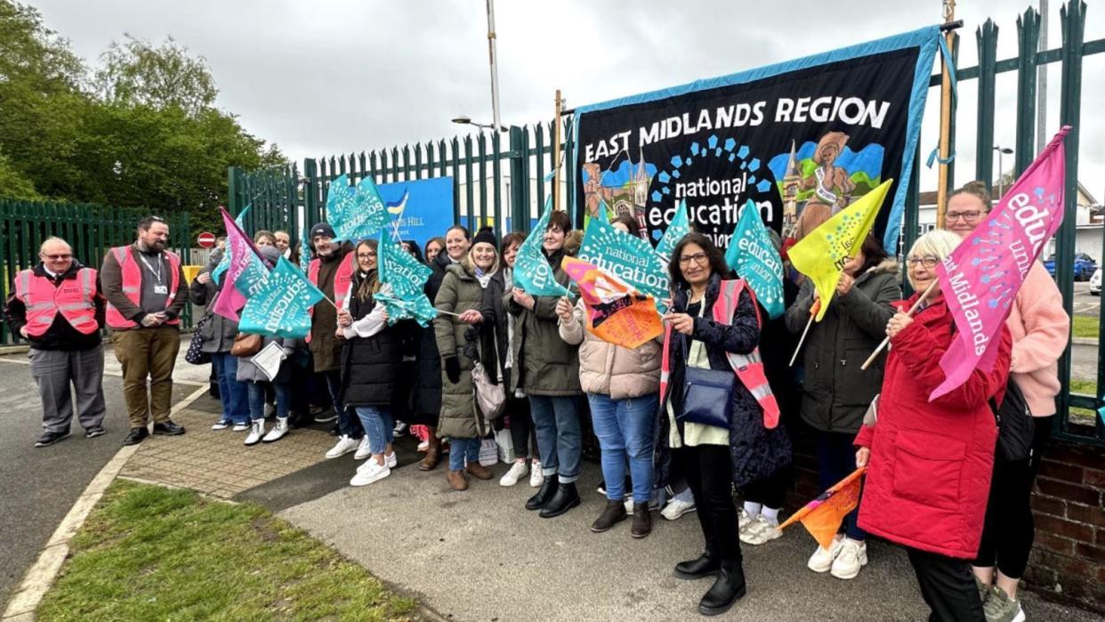 Sir Francis Hill Community Primary School staff on a picket line holding placards