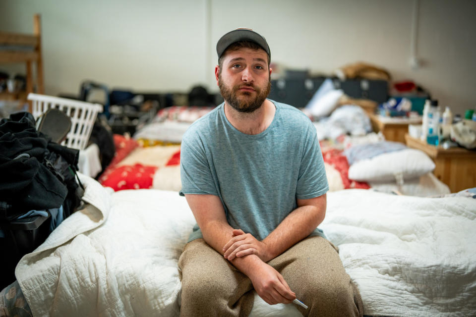  Alex Pinkney, 29, poses for a photo on his bed in the men’s dorm at Switchpoint Tooele Community Resource Center in Tooele on Friday, May 24, 2024. (Photo by Spenser Heaps for Utah News Dispatch)