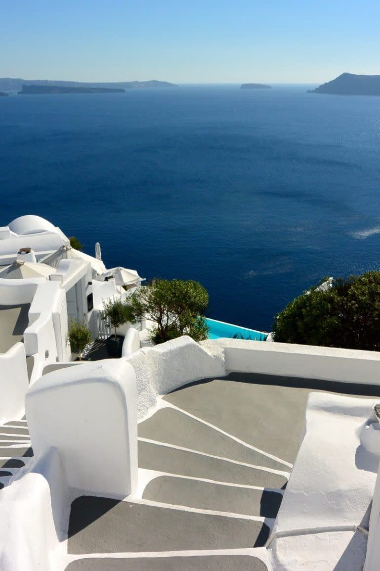 <p>White-washed villas, black sand beaches, and views of the blue Aegean Sea are a few of the reasons why this Greek island is just begging for couples to check it out.</p>