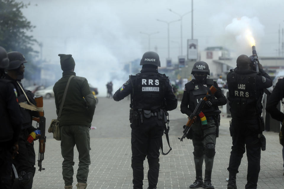 FILE - Policemen dispersed protesters with tear gas following a demonstration at Lekki Toll plaza in Lagos, Nigeria, Wednesday, Oct. 20, 2021. In a report submitted to Lagos Governor Babajide Sanwo-Olu on Monday, Nov. 15, 2021, a Nigerian judicial panel has found that soldiers of the Nigerian army "shot, injured and killed" protesters during the Oct. 2020 nationwide demonstrations against police brutality in the country's most populous city Lagos. (AP Photo/Sunday Alamba, File)