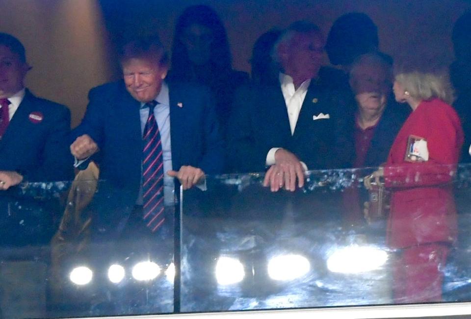Former President Trump is seen acknowledging the crowd at Williams-Brice Stadium in Columbia, S.C. Saturday night. Trump was seated in the governor's box seat with South Carolina Gov. Henry McMaster and other South Carolina dignitaries.