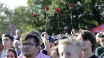 <p>Roses are held up during a prayer vigil following a shooting at Santa Fe High School in Santa Fe, Texas, on Friday, May 18, 2018. Dimitrios Pagourtzis, 17, has been charged with capital murder in the Friday morning deadly shooting in Santa Fe, near Houston and Galveston. (Photo: David J. Phillip/AP) </p>