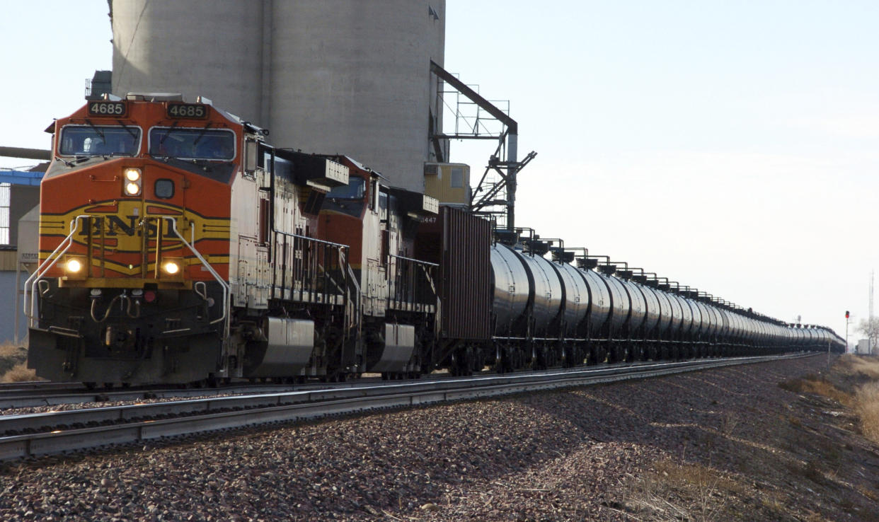 FILE - In this Nov. 6, 2013, file photo, a BNSF Railway train hauls crude oil near Wolf Point, Mont. The Trump administration vastly understated the potential benefits of installing more advanced brakes on trains that haul explosive fuels when it cancelled a requirement for railroads to begin using the equipment. A government analysis used by the administration to justify the cancellation omitted up to $117 million in potential reduced damages from using electronic brakes. Department of Transportation officials acknowledged the error after it was discovered by The Associated Press during a review of federal documents but said it would not have changed their decision. (AP Photo/Matthew Brown, File)