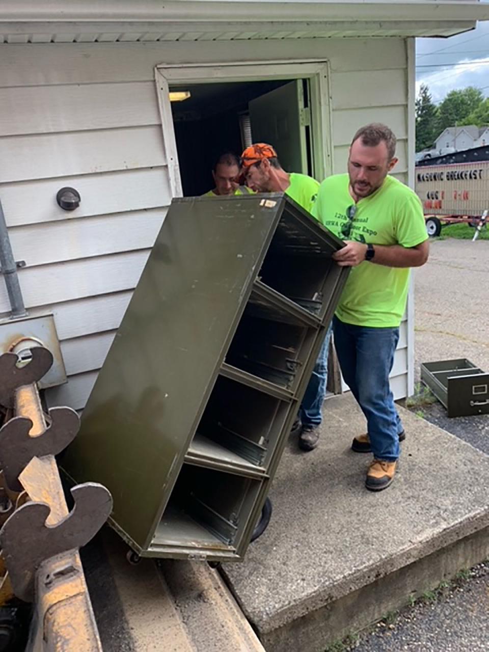 Colon DPW employee Nate Martin loads a file cabinet onto a front-end loader Tuesday at the former village office. After years working from a cramped office, village staff and the municipality's operations have relocated to 111 S. St. Joseph St.